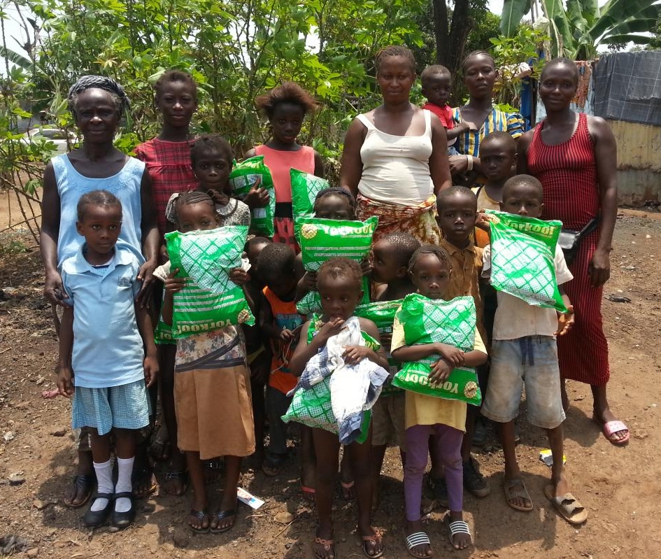family holding donated mosquito nets