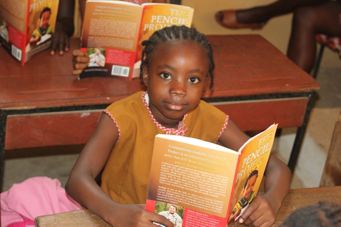 Girl reading book at school in Sierra Leone