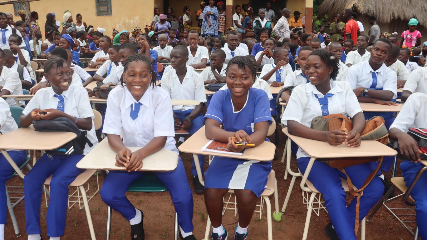 Students at newly donated desks 
