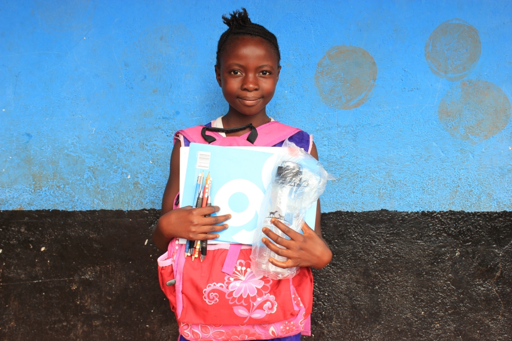 Binta, girl with school supplies 