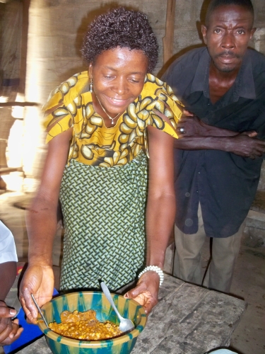 Isata serves food at her microfinance business