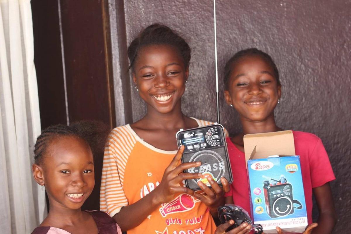 Kids with radios so they can listen to education programs