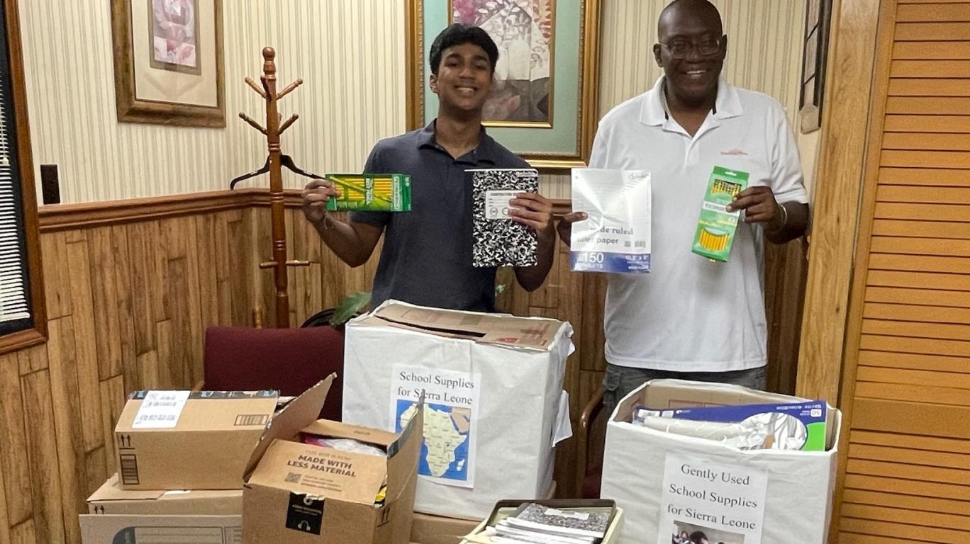 Bhargav and Sylvester with school supplies collected