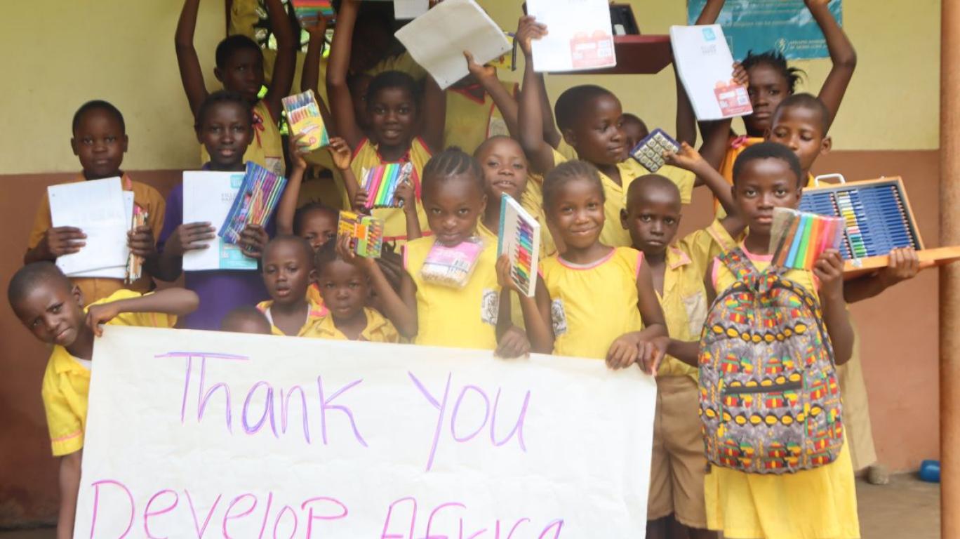 happy kids with school supplies on Banana Island Sierra Leone