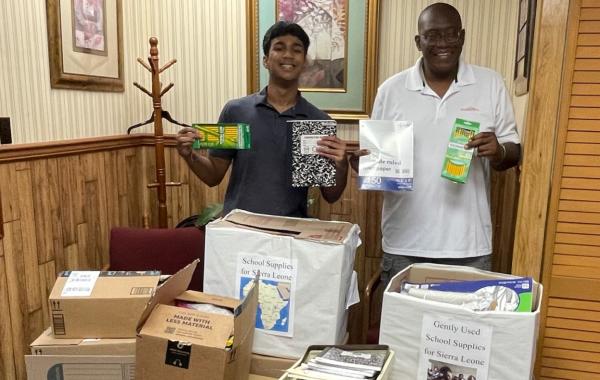 Bhargav and Sylvester with school supplies collected