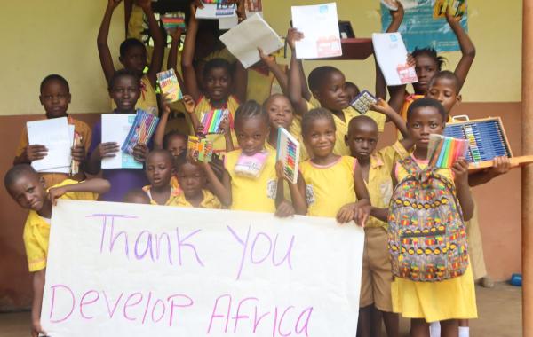 happy kids with school supplies on Banana Island Sierra Leone