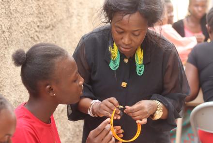 Entrepreneur Showing Girls How Make Bead Designs