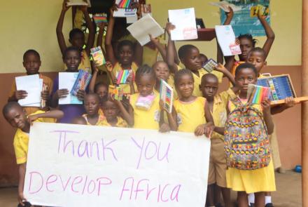 happy kids with school supplies on Banana Island Sierra Leone