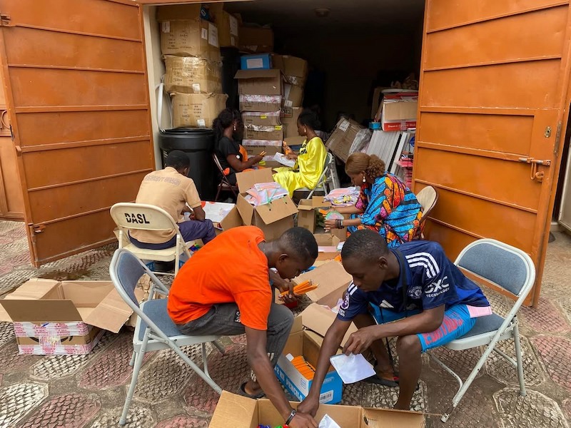 Volunteers at Develop Africa Sierra Leone packing pencils into pencil pouches